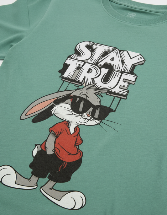 Pink t-shirt with cartoon character and 'Stay True' text on a light pink background