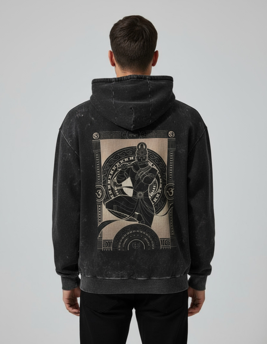 Person wearing a black hoodie with a graphic design on the back against a light gray background