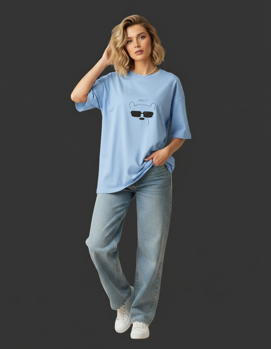 Woman wearing a pink t-shirt with a graphic design on a dark background